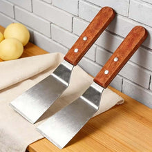 Load image into Gallery viewer, Multi-Purpose Stainless Steel Kitchen Spatula - Ice Removal Shovel, Cleaning Scraper, Degrease Tool - Angled set on wooden table.