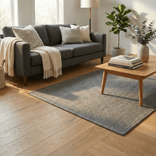 تحميل الصورة في عارض المعرض، Living room with a gray sofa, wooden coffee table, and decorative items.