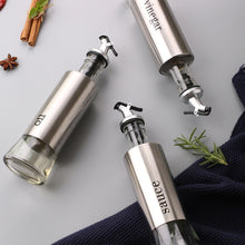 Load image into Gallery viewer, Stainless steel oil and vinegar dispenser set with glass bodies, featuring non-drip spouts for easy pouring.