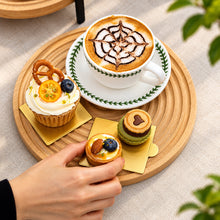 تحميل الصورة في عارض المعرض، Cup of coffee with decorative art, cupcake, and small pastries on a wooden tray.