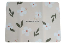 Load image into Gallery viewer, A rectangular desk mat with a floral pattern of white flowers and green leaves on a beige background, featuring the text 'BE AWESOME TOUCH' in the center, placed on a wooden desk.