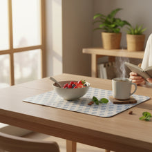 Load image into Gallery viewer, A rectangular mouse pad with rounded corners, featuring a repeating blue floral or leaf-like pattern on a white background, placed on a wooden desk.