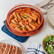 تحميل الصورة في عارض المعرض، Baked carrots in a wire basket on a white table with bread and salad.