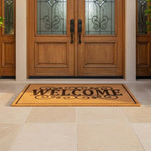 Load image into Gallery viewer, Wooden front door with decorative glass panels and a 'Welcome' mat on a stone patio.