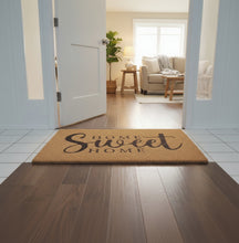 تحميل الصورة في عارض المعرض، Doormat with 'Home Sweet Home' text on a wooden floor.