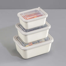Load image into Gallery viewer, Set of three stacked food storage containers with lids on a gray background