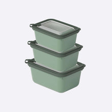 Load image into Gallery viewer, Set of three green food storage containers with black lids on a white background