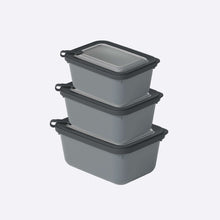 Load image into Gallery viewer, Set of three gray food storage containers with black lids on a white background