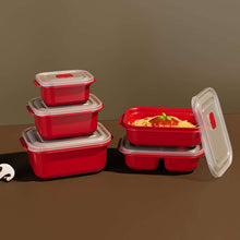 تحميل الصورة في عارض المعرض، Set of red food storage containers with one open showing spaghetti on a brown background