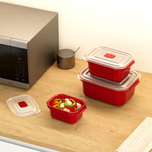 تحميل الصورة في عارض المعرض، Red food storage containers with lids on a wooden surface next to a microwave.