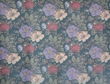 Load image into Gallery viewer, Floral patterned placemat with colorful flowers on a teal background