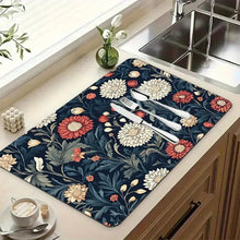 Load image into Gallery viewer, Floral-patterned mat on a kitchen counter with cutlery and a cup.