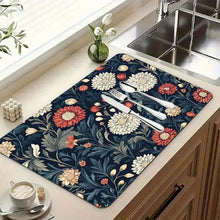 Load image into Gallery viewer, Floral-patterned mat on a kitchen counter with cutlery and a cup.