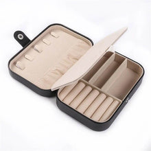 Load image into Gallery viewer, Leather portable travel jewelry box open, showcasing compartments for rings, earrings, and necklaces.