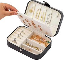Load image into Gallery viewer, Leather portable travel jewelry box open, featuring organized earrings, rings, and necklaces in a compact design.
