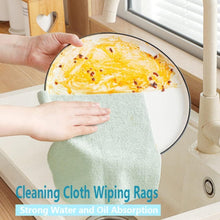 Load image into Gallery viewer, Person using a microfiber cleaning cloth to wipe a plate at the sink showcasing strong water and oil absorption.