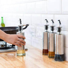 تحميل الصورة في عارض المعرض، Olive oil dispenser and vinegar cruet set made of stainless steel and glass on a kitchen counter.