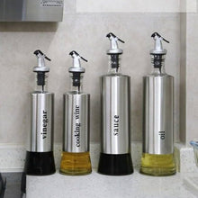 Load image into Gallery viewer, Stylish stainless steel and glass dispenser set for oil, vinegar, cooking wine, and sauce in a modern kitchen.