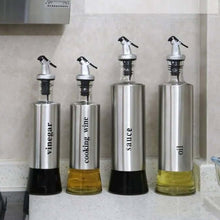 تحميل الصورة في عارض المعرض، Stylish stainless steel and glass dispenser set for oil, vinegar, cooking wine, and sauce in a modern kitchen.