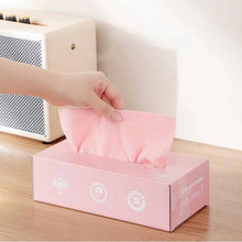تحميل الصورة في عارض المعرض، Hand pulling a pink microfiber cleaning cloth from a convenient box on a wooden table.