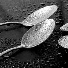 تحميل الصورة في عارض المعرض، Two silver spoons with water droplets on a textured black surface