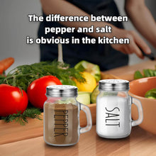 Load image into Gallery viewer, Vintage glass salt and pepper shakers set with handles on a kitchen counter, highlighting their classic design.