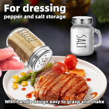 Load image into Gallery viewer, Vintage glass salt and pepper shakers with handles for easy seasoning on a plate of steak.