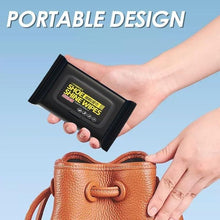 Load image into Gallery viewer, Hand holding portable shoe shine wipes, easy to carry in purse for on-the-go cleaning of shoes.