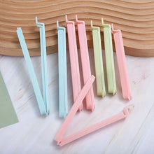 Load image into Gallery viewer, Set of colorful plastic straws on a wooden surface