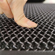 Load image into Gallery viewer, Close-up of a finger pressing a 3D mesh layer of a high-elastic outdoor doormat, showcasing its dirt-trapping design.