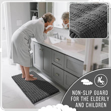 Load image into Gallery viewer, Woman using a textured bath mat in a bathroom with close-up of the mat's texture.