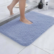 تحميل الصورة في عارض المعرض، Person stepping onto a blue bath mat in a bathroom setting.