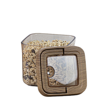 Load image into Gallery viewer, Square glass container with wooden lid filled with small stones on a white background