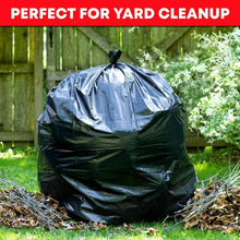 Load image into Gallery viewer, Large black trash bag on grass with 'Perfect for Yard Cleanup' text