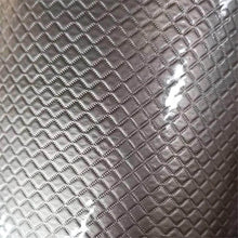 Load image into Gallery viewer, Close-up of a textured metallic surface with a diamond pattern