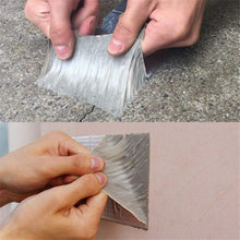 Load image into Gallery viewer, Hands applying a strip of adhesive tape to a surface.