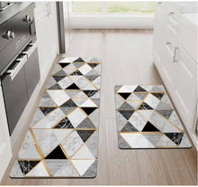 Load image into Gallery viewer, Geometric patterned rug set on a wooden floor in a kitchen.