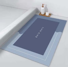 Load image into Gallery viewer, Blue bath mat with 'Bath Mats' text on a white bathtub