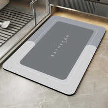 Load image into Gallery viewer, Gray bath mat with 'Bathroom' text on a tiled floor