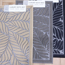 تحميل الصورة في عارض المعرض، Three bath mats with leaf patterns on a wooden floor.