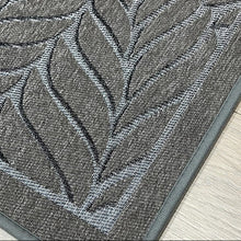 تحميل الصورة في عارض المعرض، Gray textured rug with leaf pattern on a wooden floor, featuring the Socony brand logo.