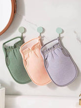 Load image into Gallery viewer, Three colorful exfoliating loofah gloves hanging on hooks in a bathroom setting, ideal for smooth skin.