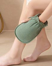Load image into Gallery viewer, Person using a green exfoliating loofah glove on their leg in a shower setting, showcasing effortless skin exfoliation.