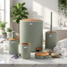 تحميل الصورة في عارض المعرض، Set of cylindrical green planters with wooden bases in front of a building.