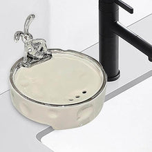 Load image into Gallery viewer, Elegant porcelain soap holder with drainage, featuring a silver-glazed finish, placed beside a modern faucet in a bathroom.