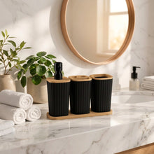 تحميل الصورة في عارض المعرض، A 3-piece bathroom set featuring three ribbed black cylindrical containers with light natural wood lids, displayed on a matching wooden base. The set is styled in a warm, modern bathroom setting with Turkish text overlays highlighting its bamboo details and features.