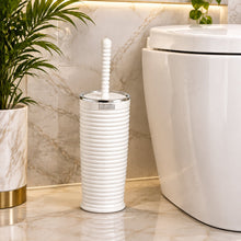 تحميل الصورة في عارض المعرض، A white toilet brush with a ribbed cylindrical handle and a silver metal ferrule, shown in front of a bathroom scene featuring a sink, mirror, and toilet.