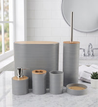 Load image into Gallery viewer, A coordinated bathroom accessory set in matte gray with light natural wood tops, including a tall oval tray, a tall toilet paper holder with metal stick, a soap dispenser, a tooth holder, a cup, a small bowl, and a lid, arranged on a white marble countertop in a bright bathroom.