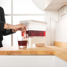 تحميل الصورة في عارض المعرض، 1 Pcs Beverage Dispenser with Dual-Use Stand - Plastic Food Container For Detox and Juice 4.5 Liters being used to serve a drink.