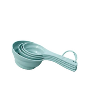 تحميل الصورة في عارض المعرض، A set of five nested measuring cups in a light mint green color, featuring integrated handles and a hanging loop at the end, shown on a plain white background.